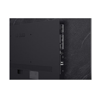 The front view of LG OLED evo AI C6, released in 2026, features a slim black bezel, with a vivid, sculpted swirl of layered rainbow tones flowing across the screen.