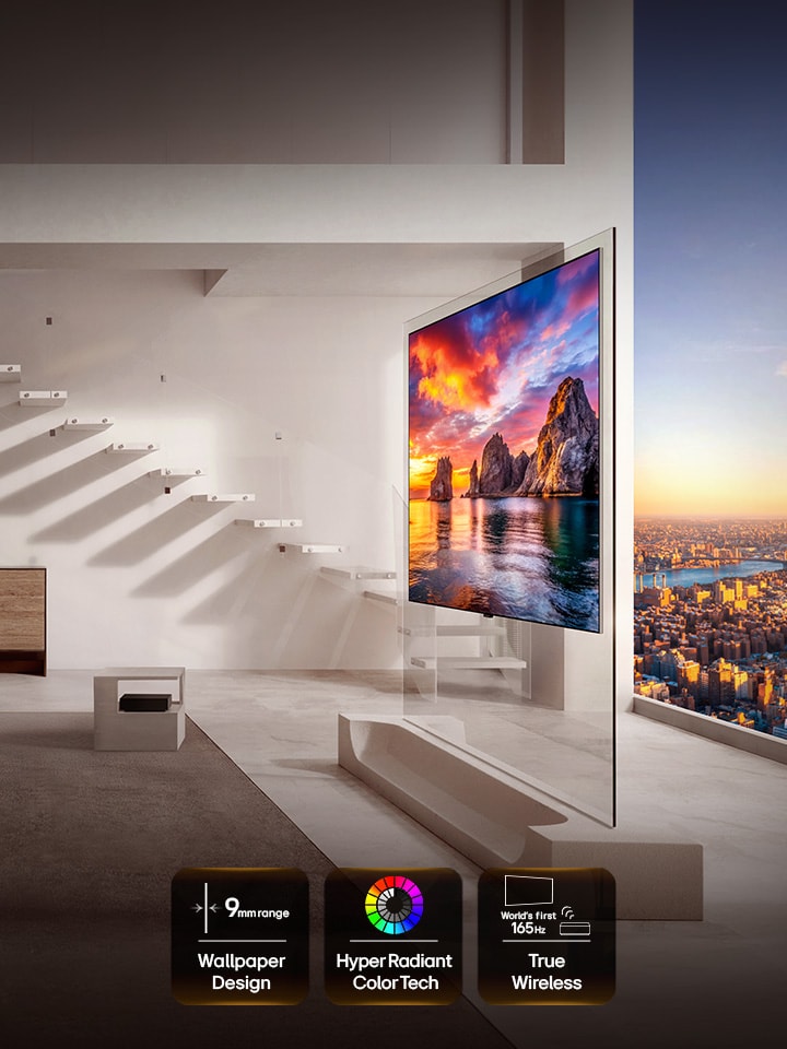 LG OLED evo AI W6 Wallpaper TV is installed in a living room with city views, showing a vivid sunset coastal scene with on-screen icons reading “9mm-range Wallpaper Design,” “Hyper Radiant Color Tech,” and “World’s First 165Hz True Wireless.”