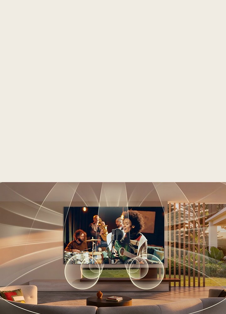 LG OLED AI B6 with Virtual 11.1.2 Ch fills a living room as a live music performance plays on screen, delivering multi-directional audio that surrounds the room and heightens immersion throughout the space. 