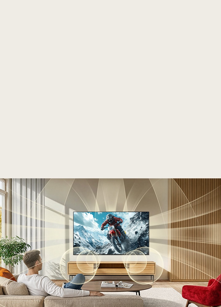 LG NANO 4K UHD AI NU85 with Virtual 11.1.2 Ch fills a room as an intense off-road motorcycle action scene plays on screen, surrounding the space with immersive, multi-directional sound.