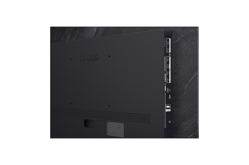 The front view of LG OLED evo AI C6, released in 2026, features a slim black bezel, with a vivid, sculpted swirl of layered rainbow tones flowing across the screen.