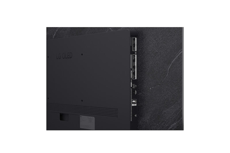 The front view of LG OLED evo AI C6, released in 2026, features a slim black bezel, with a vivid, sculpted swirl of layered rainbow tones flowing across the screen.