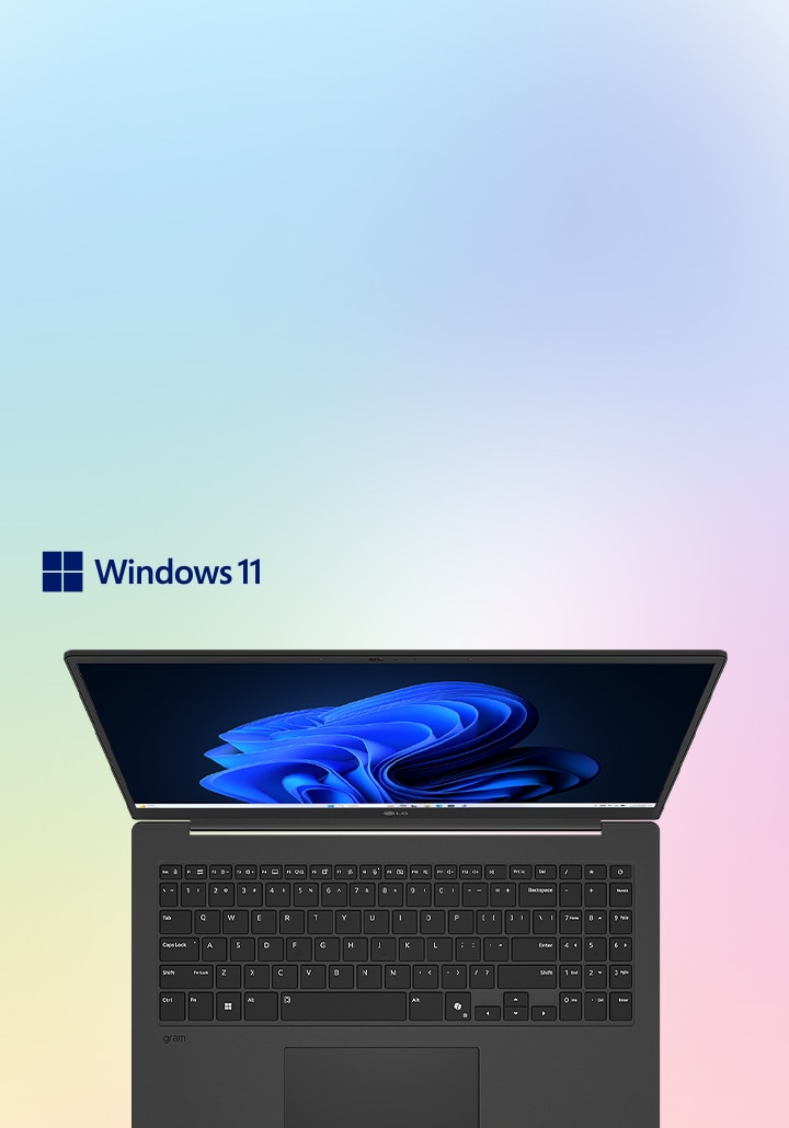 Dieses Bild zeigt einen Laptop mit einem hellblauen Display auf einem weichen Farbverlauf, der das Windows 11-Logo zeigt.