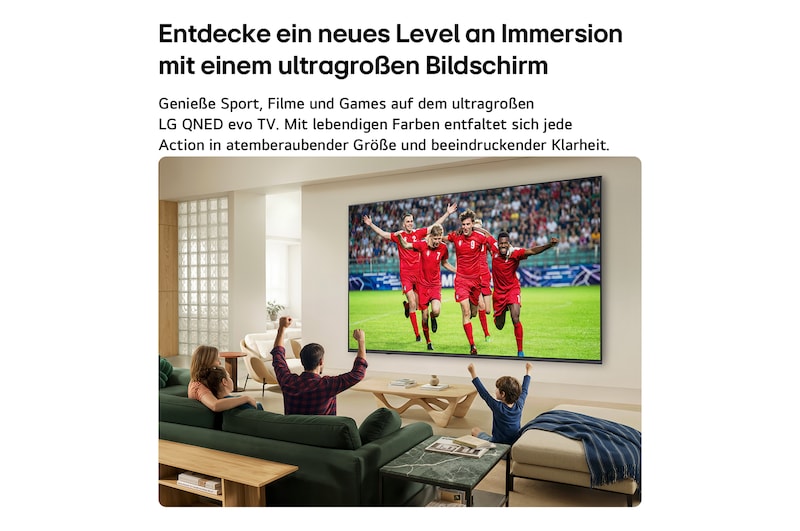 Ein in einem hellen Wohnzimmer an der Wand befestigter LG QNED evo AI QNED80 Mini LED Ultra Big TV zeigt einen intensiven Fußballjubel in lebendigen Farben und in einer gesteigerten Bildqualität auf einem Breitbildschirm. Auf Sofas sitzende Familienmitglieder jubeln gemeinsam.