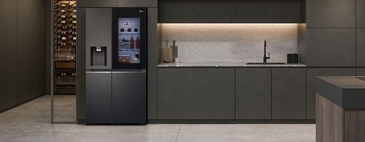 LG InstaView refrigerator with sleek black finish installed in modern minimalist kitchen interior.	