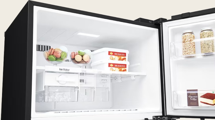 LG refrigerator freezer compartment neatly storing meat, eggs, and frozen food packs in organized shelves.