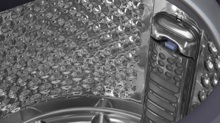 Close-up of LG top load washing machine drum showing stainless steel interior