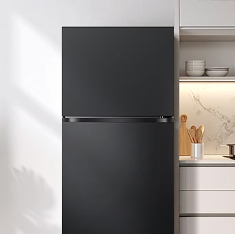 LG tall fridge with a see through glass door in a minimalist kitchen. The interior is lit with green lighting, clearly showing stored fresh groceries and beverages.