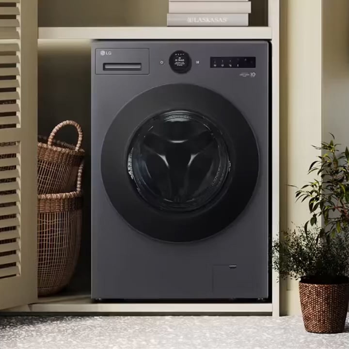 Front load washer in a compact nook beside louvered doors and plants illustrating an easy fit in small spaces.