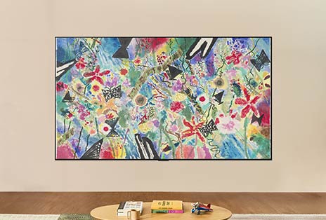 LG OLED evo AI G6 is wall-mounted in a bright room, showing a colorful floral-and-fruit artwork in Gallery Mode while brightness control adjusts for optimal viewing in any light.