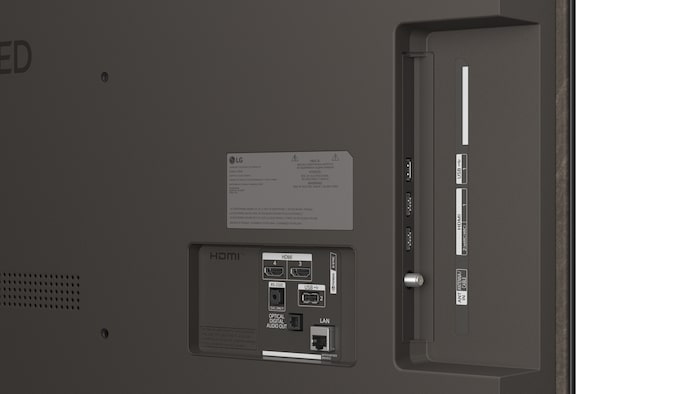 La vue avant de la LG OLED AI B6, lancée en 2026, présente un fin cadre noir, avec une image éclatante et sculpturale de formes multicolores richement superposées remplissant l’écran.