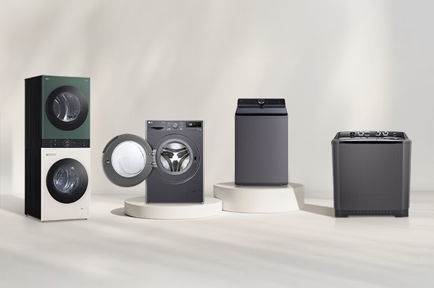 LG washer and dryer lineup in front of a beige wall. Includes a tumble dryer, front load washer with open door, washer dryer combo, and WashTower. A forest view is visible on the right.	