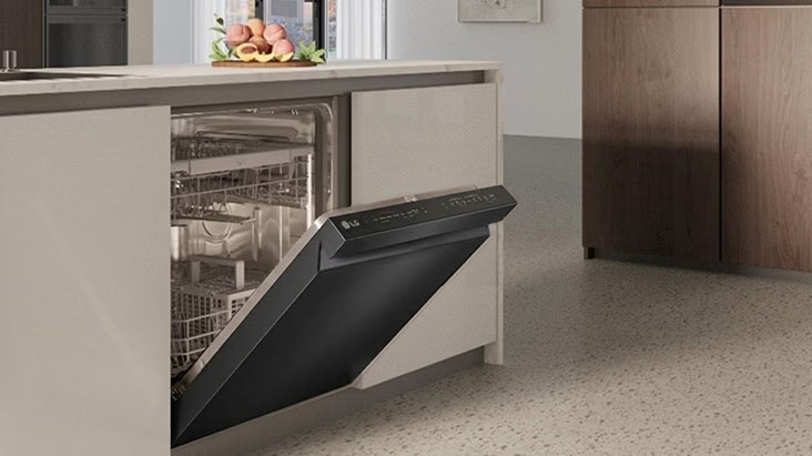 LG dishwasher with open door and visible racks, built into a light kitchen island with clean cabinetry and minimal design.	