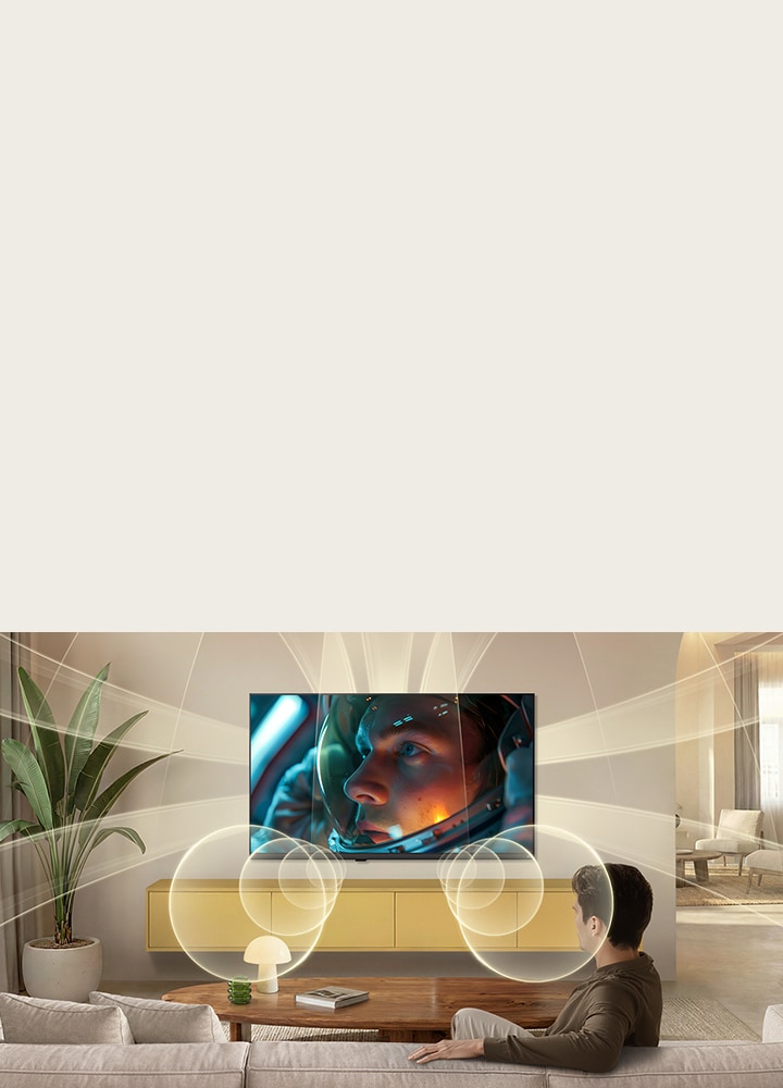LG SMART TV AI LB65 with Virtual 9.1.2 Ch by AI Sound fills a modern living space as an astronaut movie scene plays on screen, surrounding the room with multi-directional sound for a deeply immersive experience.