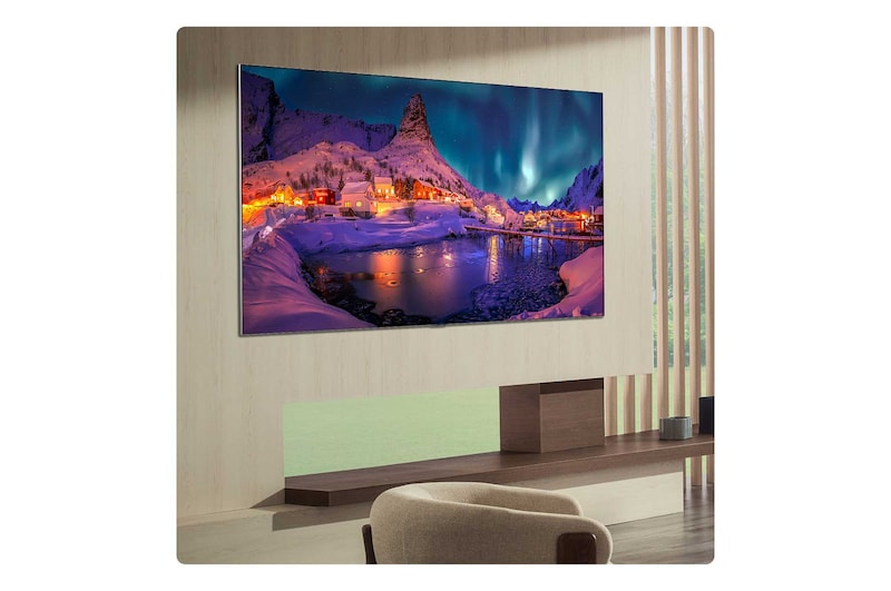 LG OLED evo AI G6 is flush-fit wall-mounted in a modern lifestyle living room, displaying a vivid aurora over a serene coastal village, resembling a framed picture on the wall.