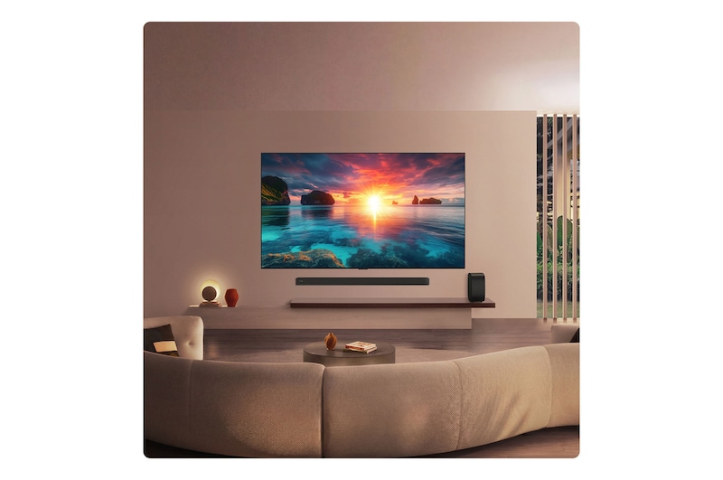 LG OLED evo AI G6 displays a vivid ocean sunset scene, with a soundbar and speaker positioned below the screen, enhancing a calm and atmospheric living space.