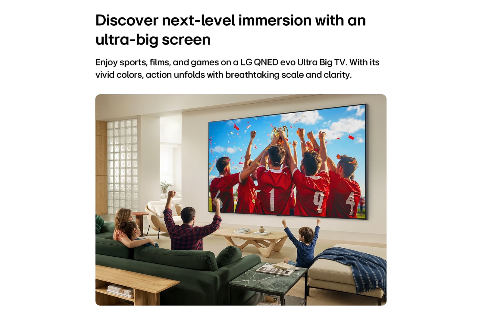 LG QNED evo AI QNED85 Mini LED Ultra Big TV is wall-mounted in a living room, displaying a sports victory celebration with vivid colors and refined picture quality across the wide screen as a family cheers together.