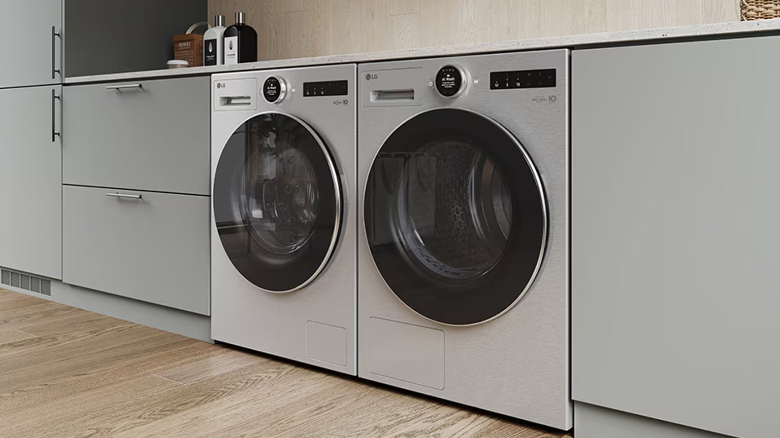 Lavatrice e asciugatrice LG installate fianco a fianco in un armadio integrato, mostrato in una moderna lavanderia.