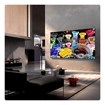 LG Mini RGB evo AI MRGB85 закреплен на стене в просторной современной гостиной и демонстрирует яркое абстрактное произведение искусства с вихревыми разноцветными элементами.