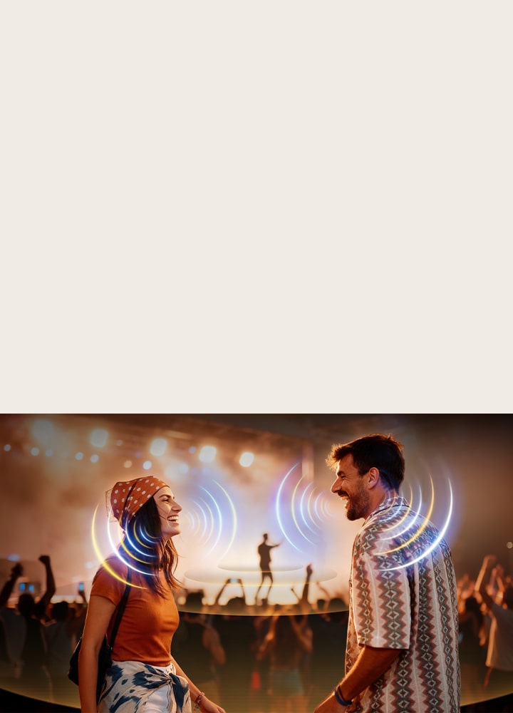 LG Micro RGB evo AI MRGB95 with AI Object Remastering Ultra shows two people facing each other at a crowded concert, clarifying voices amid loud background noise and delivering crystal-clear, immersive audio.	