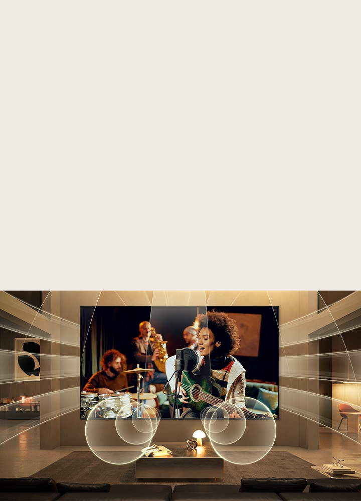 LG Micro RGB evo AI MRGB95 with Virtual 11.1.2 Ch fills a living room as a live music performance plays on screen, delivering multi-directional audio that surrounds the room and heightens immersion throughout the space. 	