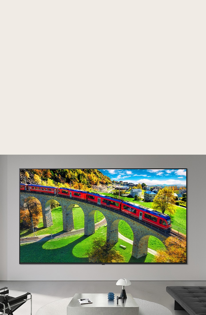 LG Micro RGB evo AI MRGB95, offering up to 100 inches, is wall-mounted in a spacious modern living room. Displaying a vivid, colorful landscape that highlights rich color and fine detail, elevating the interior to a new level. 	