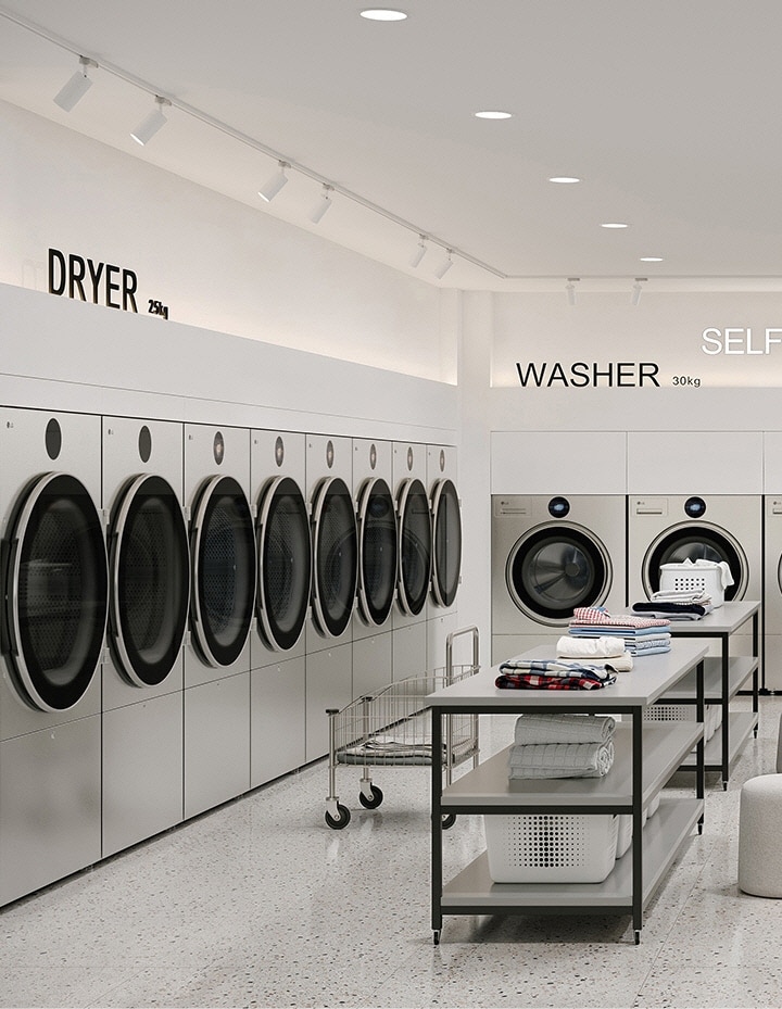 Symmetrical self service laundry layout with washers dryers, folding tables, and seating area
