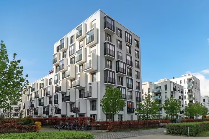 Exterior view of a modern apartment complex suitable for shared commercial laundry solutions	