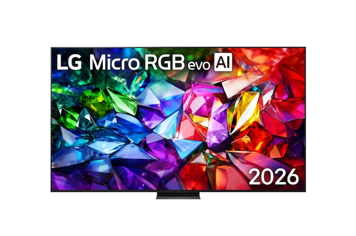 The front view of LG Micro RGB evo AI MRGB96, released in 2026, features a slim black bezel on low-profile feet, with a vivid, crystalline image of sharply defined red, green, and blue facets filling the screen. 