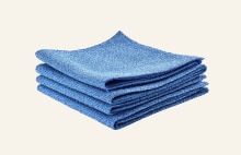 Blue microfiber cleaning cloths used for wiping and maintaining LG washing machine surfaces for effective cleaning care	