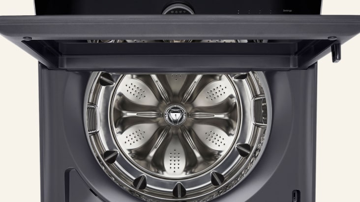 LG top load washing machine with open lid showing clean stainless steel drum	