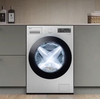White front load washer in a modern laundry room with water spray effect highlighting TurboWash™ 360 cleaning.
