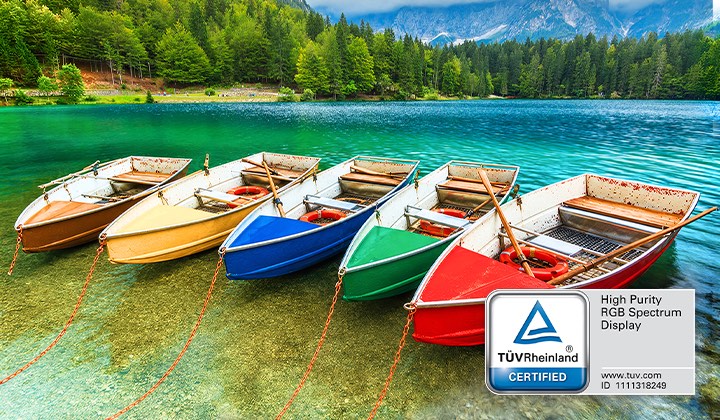 LG Mini RGB evo AI MRGB85 highlights its TÜV Rheinland Certified High Purity RGB Spectrum Display that delivers more accurate color expression by displaying a landscape scene of a row of colorful boats on a lake.