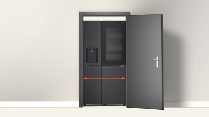 LG refrigerator placed behind an open door with red arrow showing width to check doorway clearance for installation.	