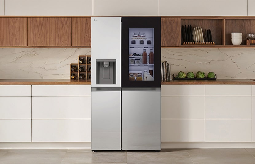 LG fridge freezer with InstaView door displayed in a modern kitchen interior with clean cabinetry and warm wood accents.