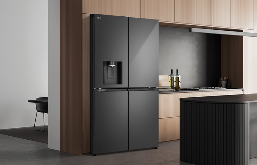 LG fridge freezer with water dispenser installed in a modern kitchen interior with island and natural light.