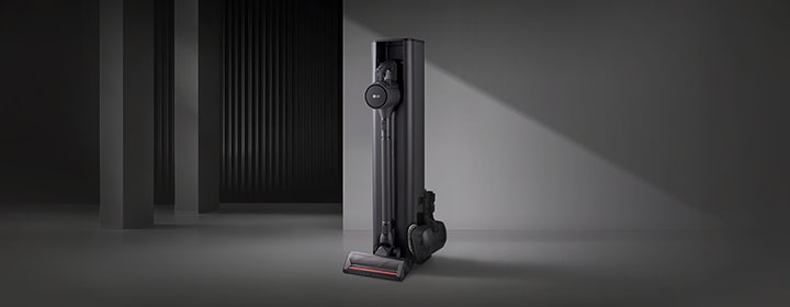 LG all-in-one vacuum tower with integrated charging and storage in a minimal interior setting.