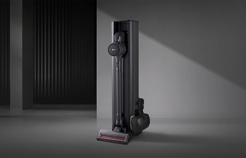 LG all-in-one vacuum tower with integrated charging and storage in a minimal interior setting.
