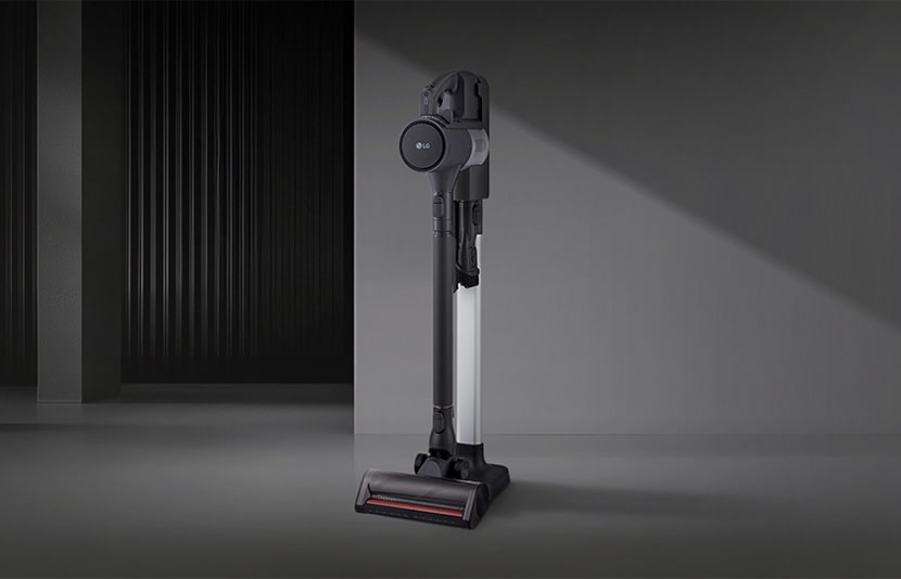 LG handstick vacuum in a floor-standing setup displayed in a modern interior space.