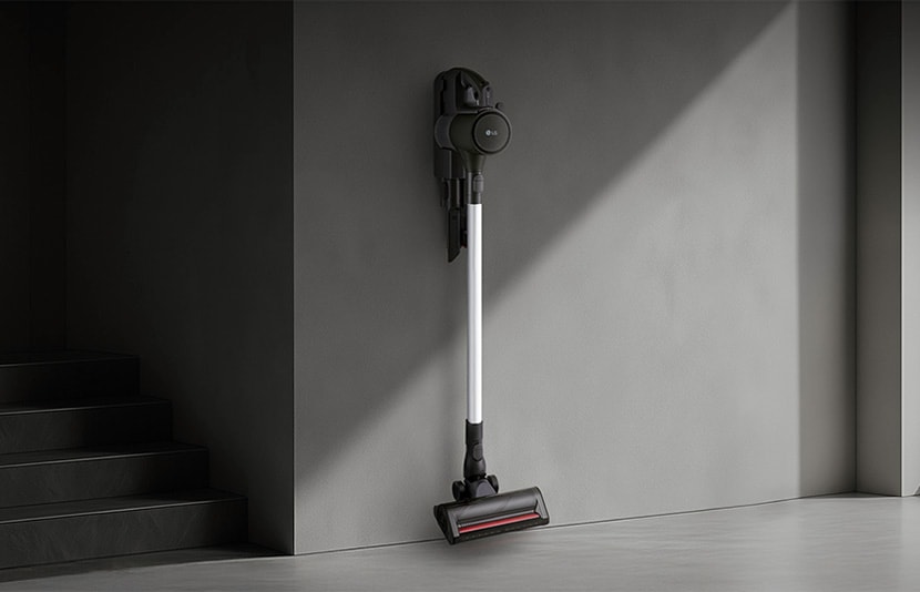 LG handstick vacuum mounted on a wall in a modern interior with clean minimalist design.