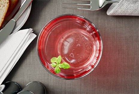 Clear glass filled with round craft ice made in an LG refrigerator.