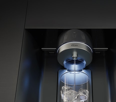 Water is flowing from a refrigerator dispenser labeled ‘UVnano,’ and the water is being poured into a cup.