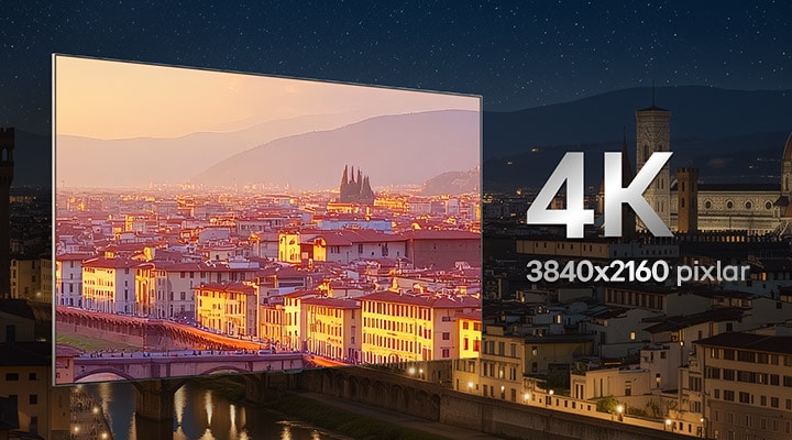 LG 4K TV visar en levande 3840x2160-upplösningsscen på en bred skärm med smal ram, med en starkt upplyst stadssilhuett vid solnedgången, vilket betonar skarp detaljrikedom, hög pixeltäthet och uppslukande klarhet för vardagsbruk.