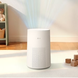 A white LG AeroMini air purifier in a room, with blue curved lines above it representing clean air circulation.	