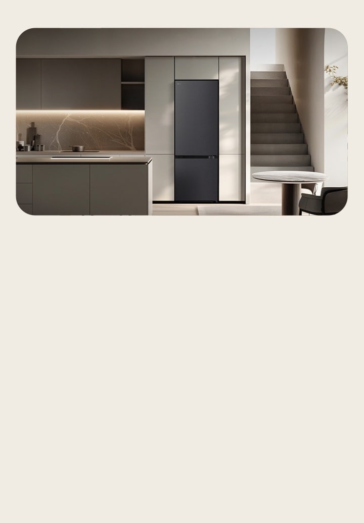 LG tall fridge freezer built into a light-colored kitchen wall next to shelving and kitchen island
