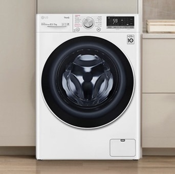LG white front load washer dryer with a split view of the interior. The left side shows clothes washing in water, while the right side shows them being dried with warm air.