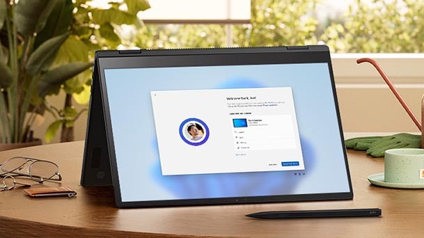 This image shows a tablet displays a Windows 11 setup screen on a wooden desk with a plant, notebook, and pen nearby, emphasizing easy file transfer.
