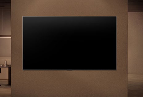 LG OLED evo AI C6 is wall-mounted with the screen off, then turns on as a person approaches, using motion sensors to display an abstract swirling artwork.