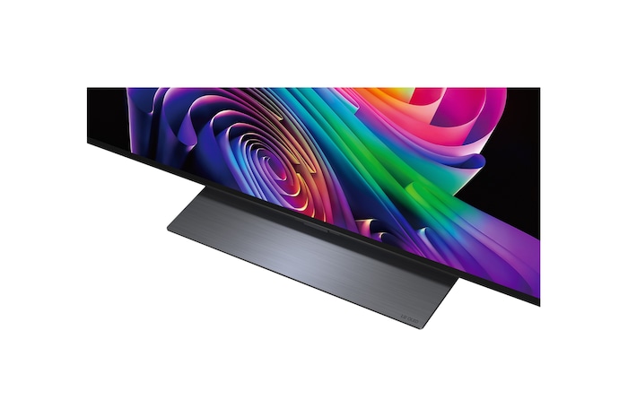 LG OLED evo AI C6 is wall-mounted in a styled living space, featuring an ultra-slim design with narrow bezels, and it displays a riverside cityscape at sunset on screen.