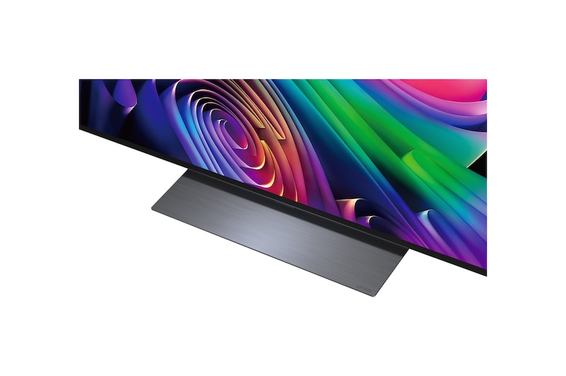 LG OLED evo AI C6 is wall-mounted in a styled living space, featuring an ultra-slim design with narrow bezels, and it displays a riverside cityscape at sunset on screen. 